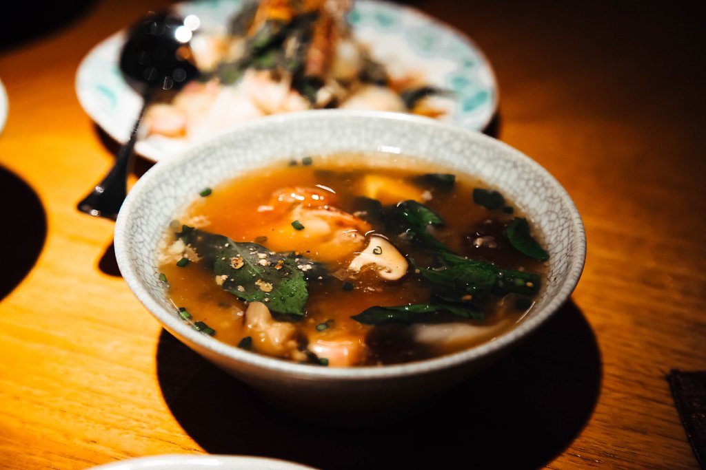 Clear soup of roast duck with thai basil and young coconut